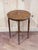 A distinguished vintage mahogany center table with beautifully executed inlay and an unmistakably English-inspired...