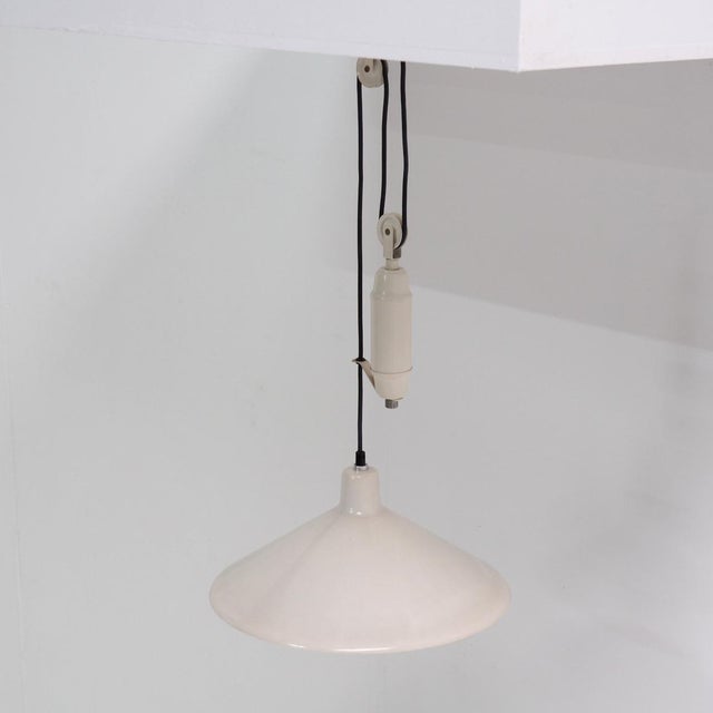 Charming counterweight pendant made in Italy in the 1960s. The shade is easily adjustable in height and can, as you can...