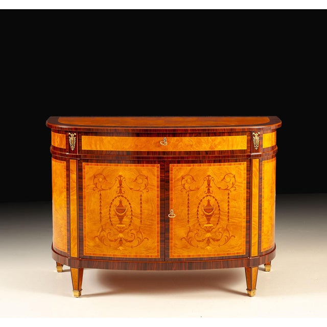 Handcrafted in Italy, this traditional credenza showcases richly figured myrtle burl veneers and fine decorative inlays....