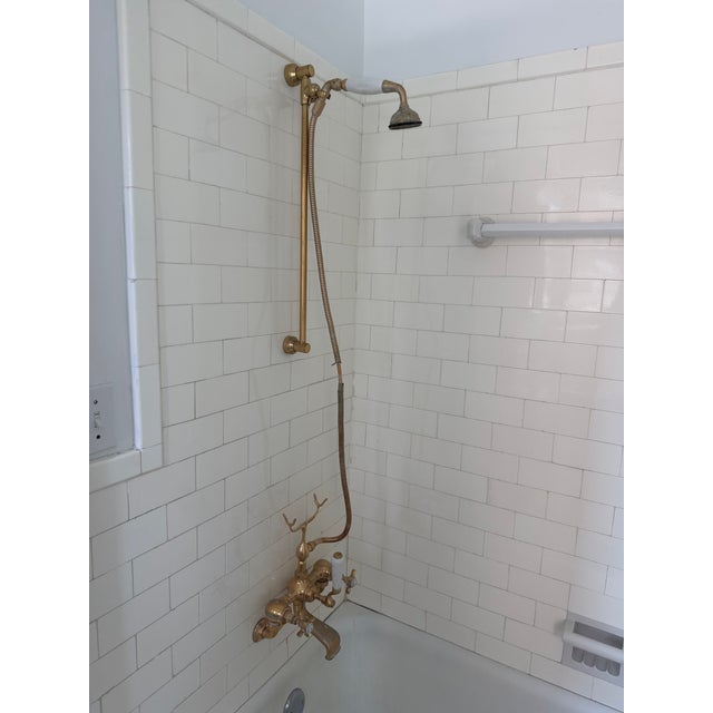 A stunning wall-mount bath and shower faucet set by Czech & Speake of London, finished in unlacquered brass with signature...