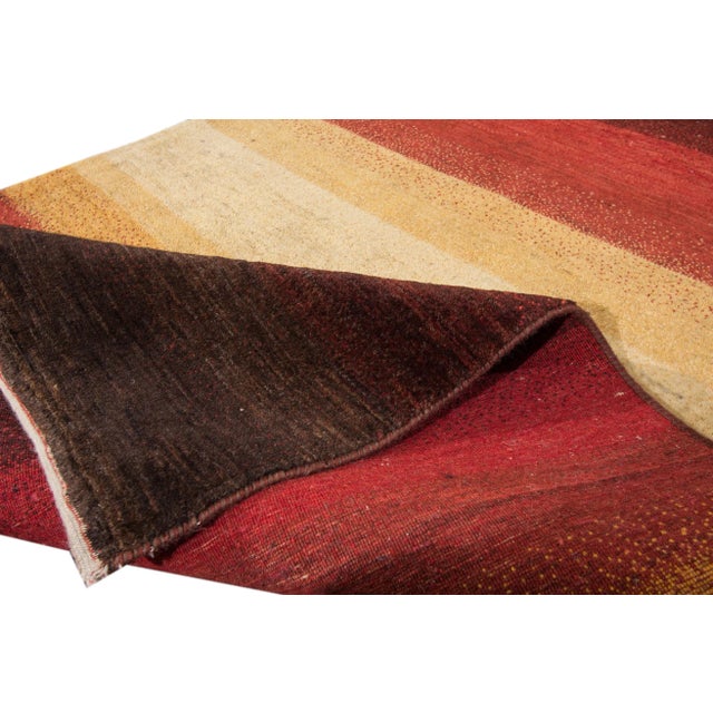 Beautiful modern Gabbeh-style hand-woven wool rug with a beige color field. This Persian rug has multicolor accents in an...