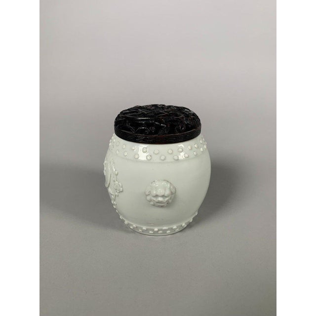 A Dehua white monochrome porcelain incense burner. Kangxi period (1661-1722). Decorated with raised branches on one side....