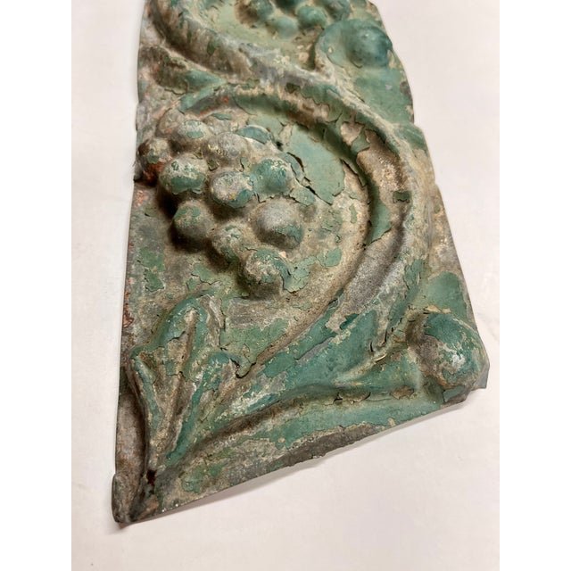 Marvelous antique pressed tin decorative panel, painted light green that's faded over time to a patina. Depicts grapes and...