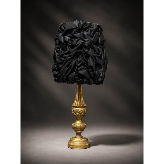 One-of-a-kind table lamp featuring an ornate antique gold-tone base with a dramatic black sculptural textured shade. The...