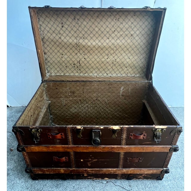 A beautiful early 20th-century flat-top travel trunk distributed by the C.W. Weeks Co. of Springfield, Massachusetts. This...