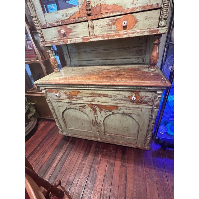 Oozing with country charm, a 19th century 2 piece stepback cupboard with key having wonderful distressed celadon green...