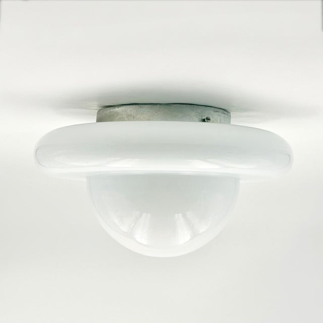 Original Italian Space Age wall or ceiling lamp produced in the 1970s. Featuring the classic UFO-inspired silhouette that...