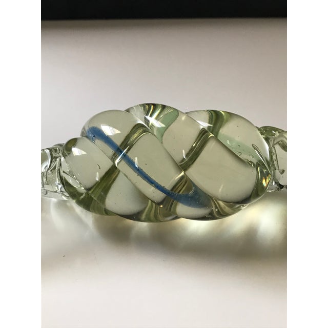 This Vintage Murano Candy is 7" in length and 3.5" wide. Mostly transparent with a streak of blue twisting through it...