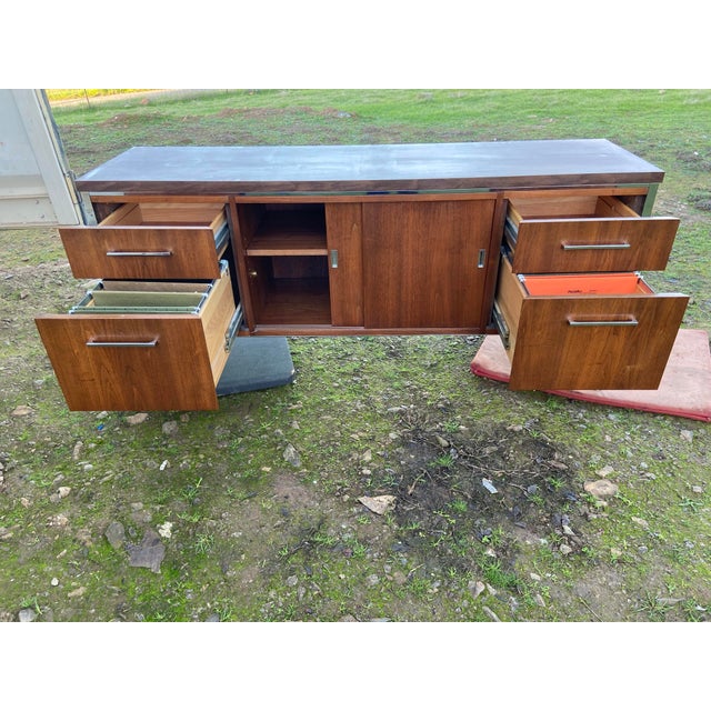 This Vintage Wood Mid Century Executive Sideboard Credenza is a stunning piece of office furniture, featuring a classic...