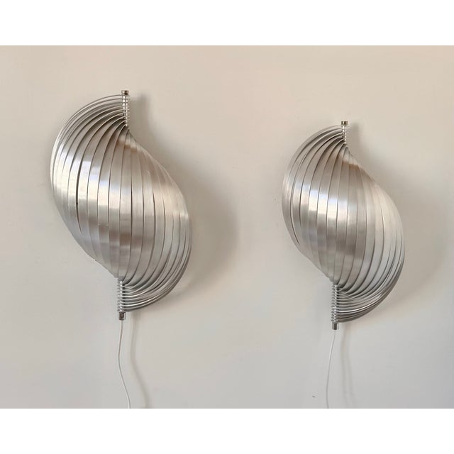 Pair of wall sconces with a metal frame, produced in France in the 1970s. An important piece of 1970s French design, this...