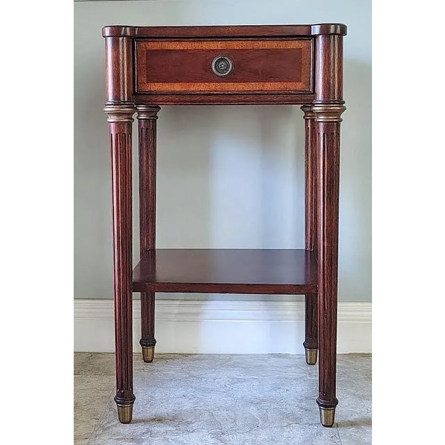 This beautiful mahogany accent table is made by Ethan Allen. It has one drawer and a bottom shelve. The drawer front is...