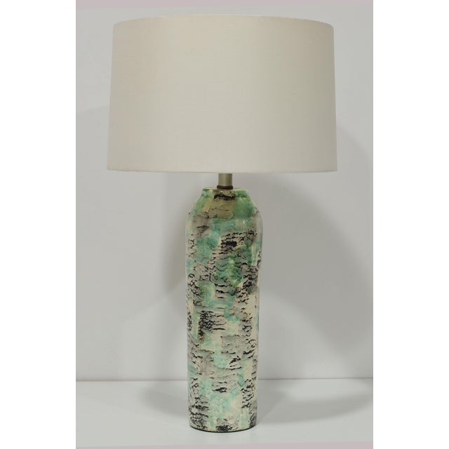 Add a touch of mid-century modern elegance to your space with the Kelby Ceramic Table Lamp, exclusively available at...