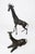 A striking matched pair of tall giraffe sculptures with an elegant, sculptural presence—one standing and one reclining....