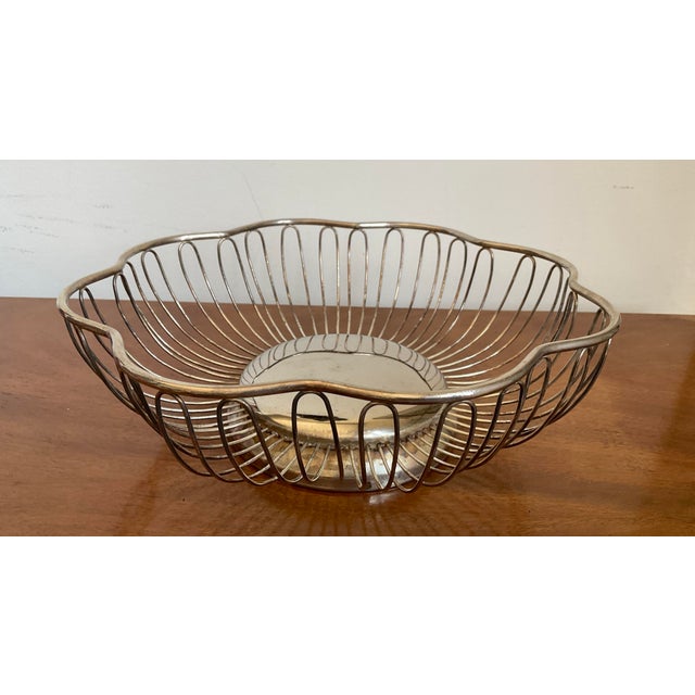 Add a touch of timeless English-inspired elegance to your table with this vintage silverplated bread basket. This piece...