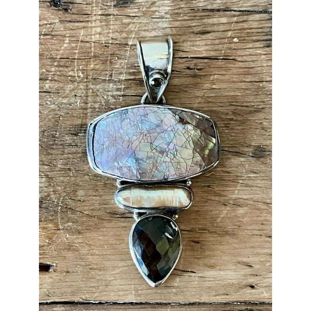 This exquisite vintage Bohemian pendant presents a striking artisanal composition, expertly uniting organic textures and...