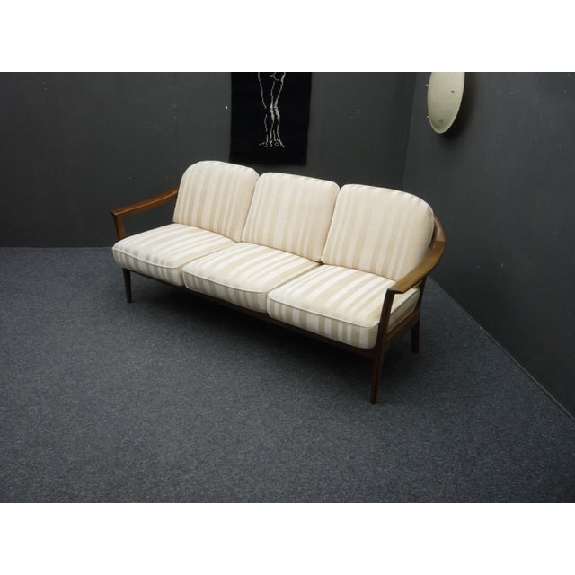 This sofa is a well-known design classic by Wilhelm Knoll. It was designed by Klaus Warzecha from Germany. Made from solid...