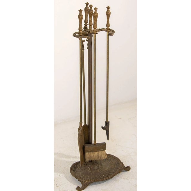 Vintage Brass American Art Nouveau Style Fireplace Tools Set. American brass and polished steel fire tools resting on a...