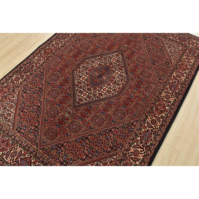 An authentic vintage traditional Bidjar rug hand-knotted with fine wool and natural dyes. This intricately woven rug...