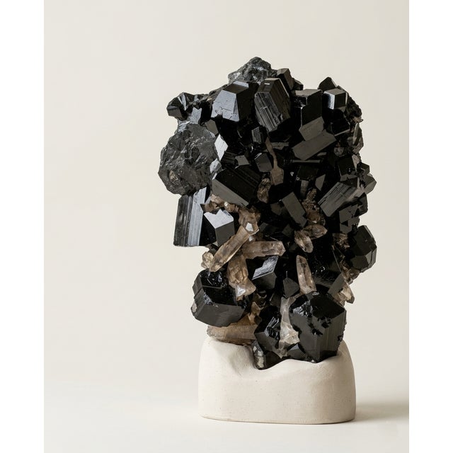 A substantial natural Namibian Black Tourmaline and Smoky Quartz matrix specimen selected for its dark architectural...