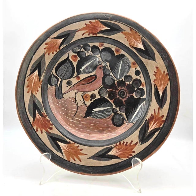 Offered is a vintage mid 20th Century decorative plate made in Tonalá, Jalisco, Mexico, a province renowned for its earth-...