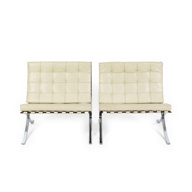 This pair of vintage mid century modern leather Barcelona lounge chairs designed by Mies van der Rohe were manufactured by...