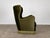 A Scandinavian mid-century wingback lounge chair, 1940s–1950s, in deep forest green velvet. A generous, fully upholstered...
