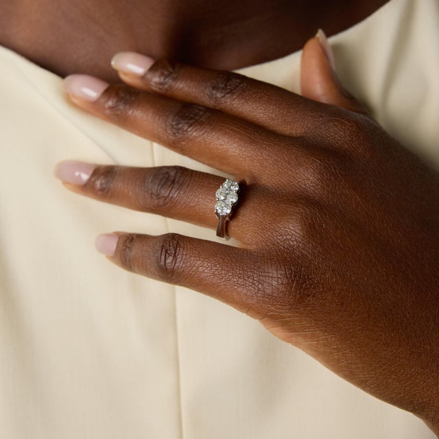 A timeless expression of elegance, this vintage three-stone ring showcases a beautiful trio of oval cut diamonds totaling...