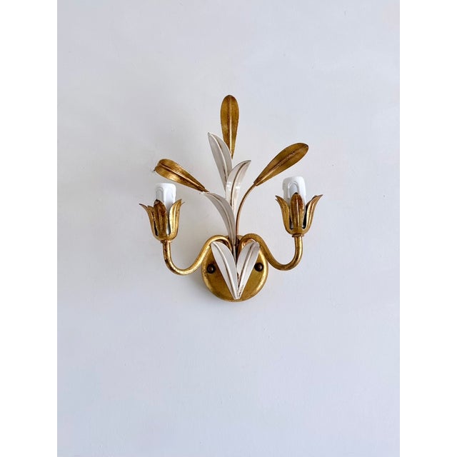 Elegant pair of vintage Italian two-light wall sconces attributed to Masca, dating from the 1970s. Each sculptural sconce...