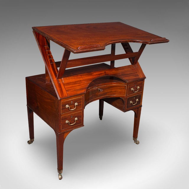 This is an antique lead architect's riser desk. An English, mahogany draughtsman or cartographer's table, dating to the...
