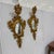 A striking pair of vintage mid-century Italian Florentine wall mirrors featuring an elongated vertical silhouette....