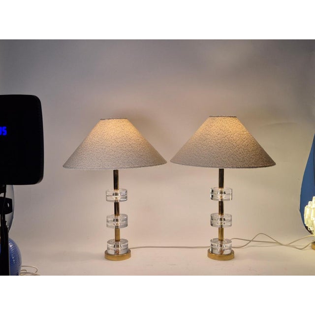A pair of elegant and timeless classics, tabel lamps with Orrefors glass and brass designed by Carl Fagerlund,...