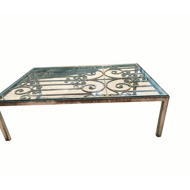 This rectangular solid iron and glass coffee table is inspired by classic vintage designs, featuring a 1/4" glass top and...