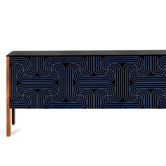 The loop sideboard three door with black doors and a carved pattern hand painted in a light blue or a dark blue. please...