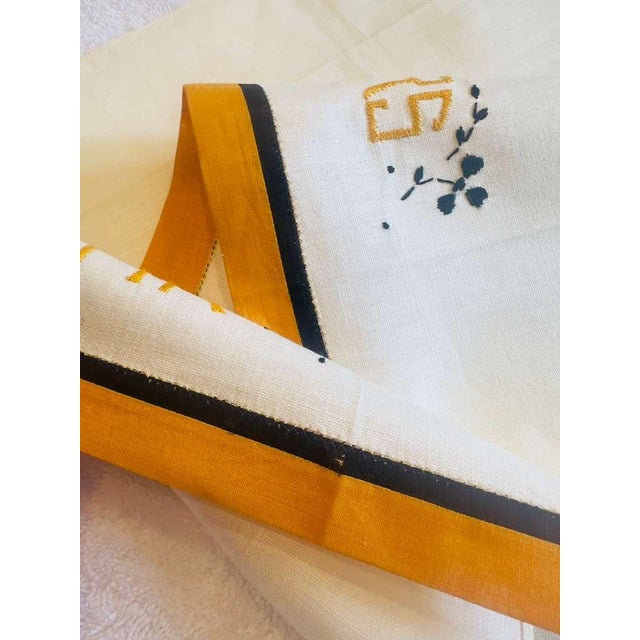 A striking pair of vintage linen towels, embroidered “Mr” and “Mrs” in a rich saffron-gold thread, framed with minimal...