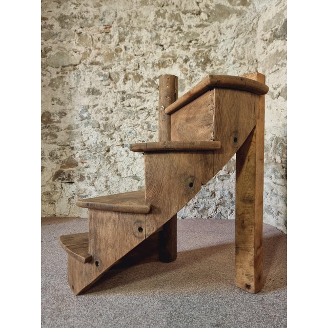 This rare architectural fragment is a section of a French spiral staircase from the early 1800s. Crafted from solid oak,...