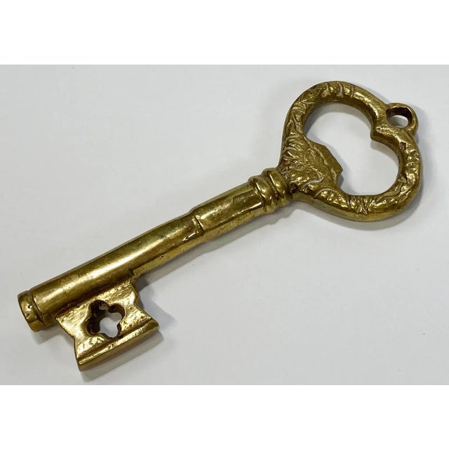 The key to my....bottle? Detailed brass key bottle opener. Hole for hanging if desired. Would be lovely strung by a ribbon...