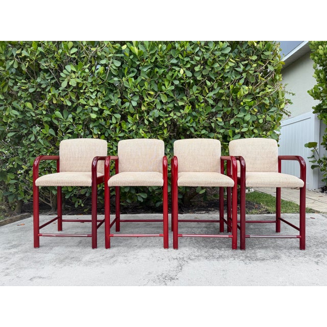 Authentic vintage Loewenstein counter stools featuring sculptural curved arm frames and a rich high-gloss stained wood...