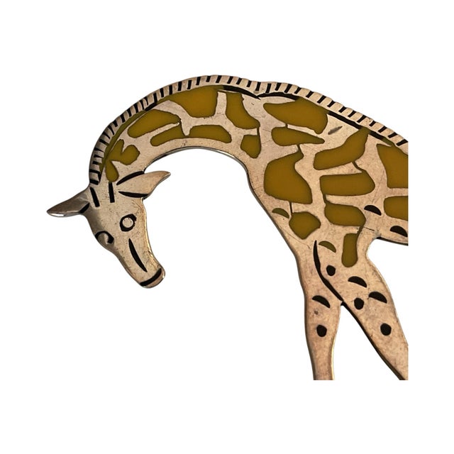 This is a sterling silver and enamel giraffe figurine. The figurine is handcrafted in Mexico from sterling silver. It...