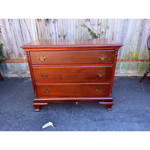 Vintage George II mahogany Chippendale chest of drawers It features stop fluted corner columns and ogee bracket feet,...