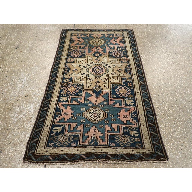 This Early 20th century Caucasian Shirvan rug, measuring 1' 9" x 3' 1", exemplifies the bold geometric artistry for which...