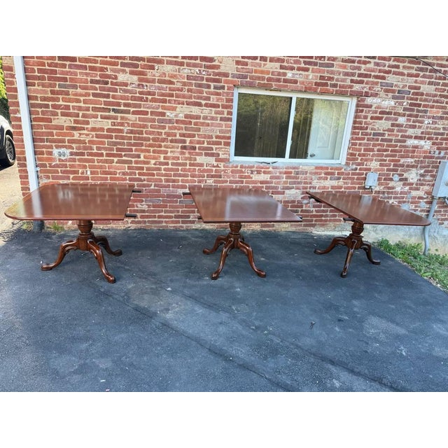 Large Geogrian style Three Triple Pedestal Base Extension Inlaid Mahogany Dining Table. It features crossbanded and reeded...