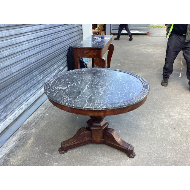 This is a classic 19th century French Guéridon table. The pedestal base is made of mahogany and supports a round gray and...