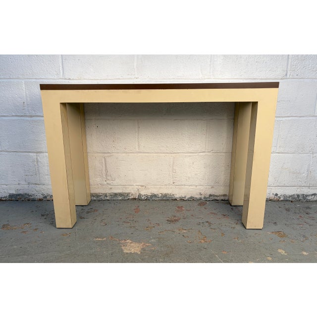 A stylish vintage console table featuring a distinctive two-tone laminate design that captures the character and charm of...
