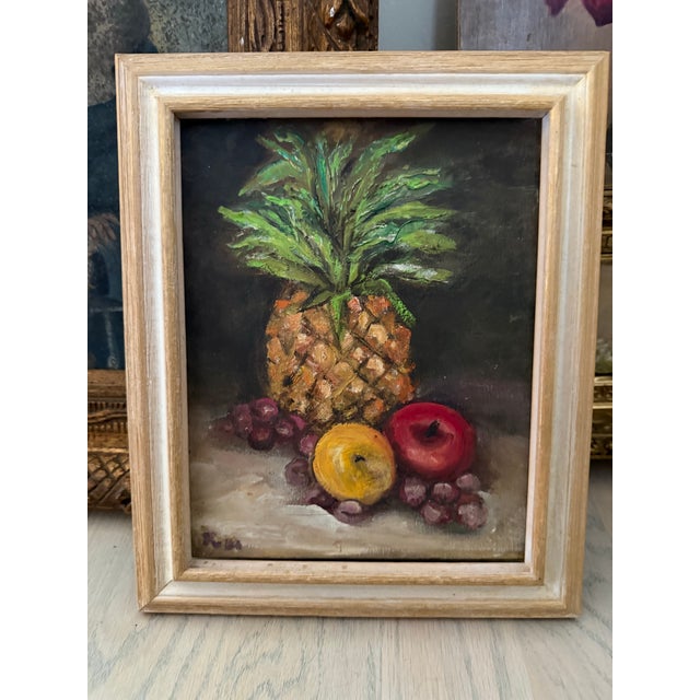 Purchased in France, this is a still life oil painting depicting an arrangement of fruits on a neutral surface against a...