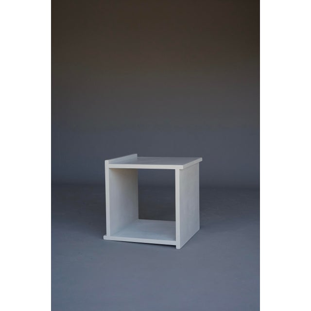 A simple minimalist cube stool in the style of Donald Judd or Gerrit Rietveld.