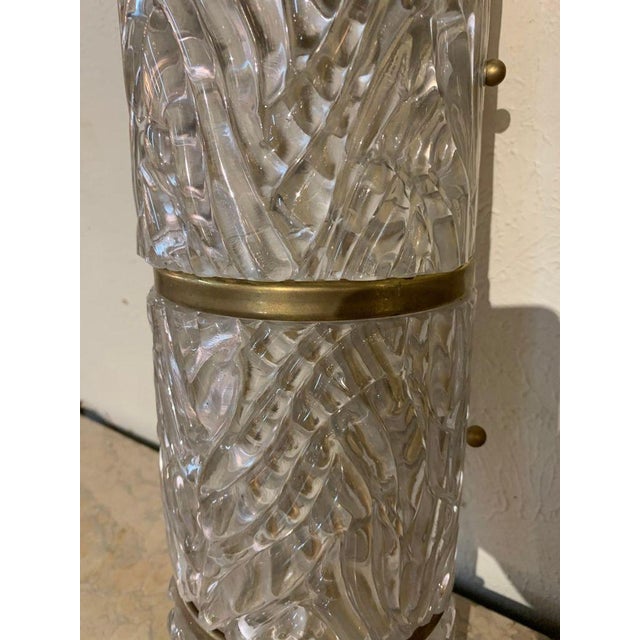 Elegant pair of midcentury barrel form Murano glass and brass sconces. These add a very textural element and create a...