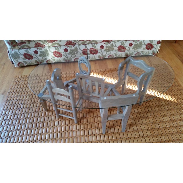 very unique coffee table with chairs as its base. it has tempered oval glass top. weathered white oak these chairs are...