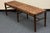 Beautiful Pottery Barn bench featuring a rubberwood frame in a warm Vintage Amber finish and a basketweave seat crafted...