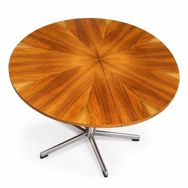 Elegant round extendable dining table produced by emu in italy during the 1960s. The table features a beautifully veneered...