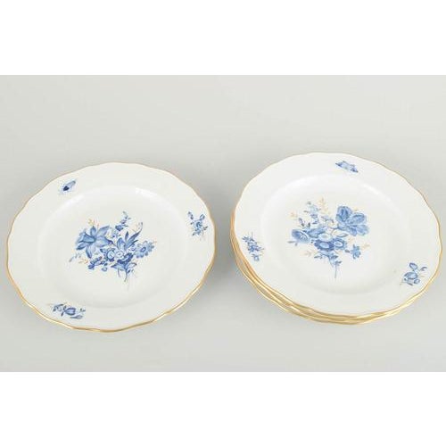 Meissen 4 lunch plates, early 20th century. Hand-decorated porcelain with hand-painted blue floral motifs and gilt accents...